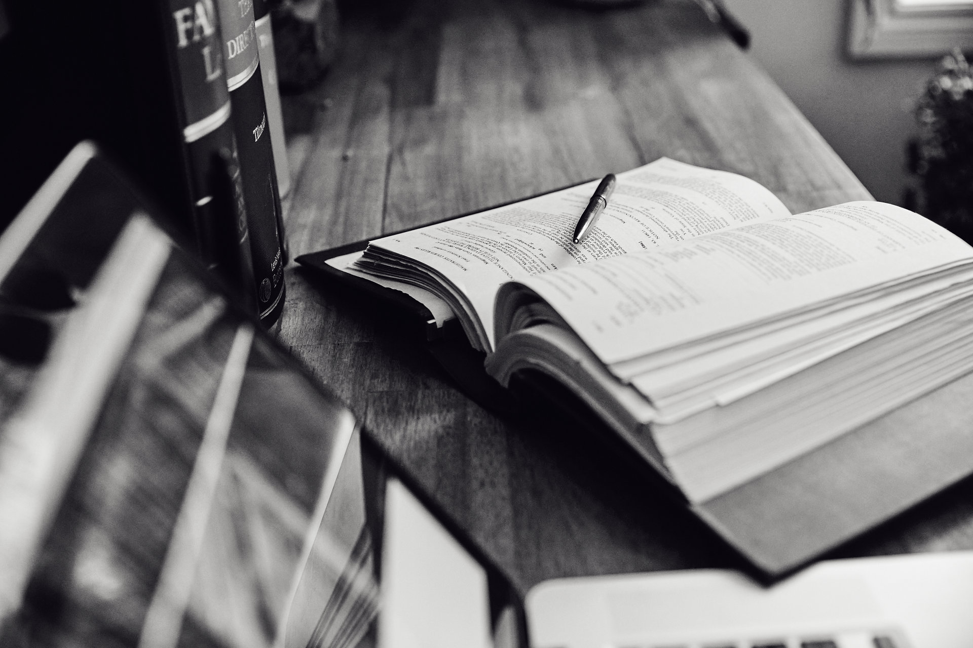 Open law book and pen on a desk